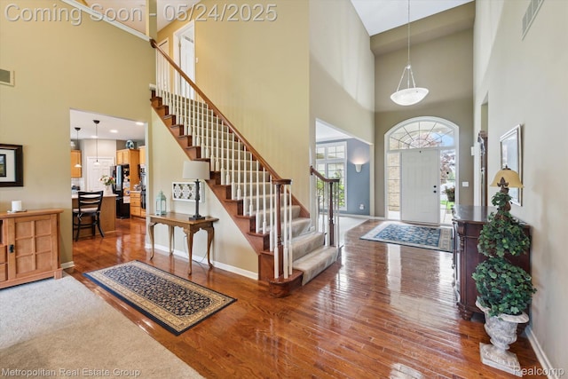 921 Gleneagles, Highland, MI 48357 - entrance foyer featuring a high ceiling, hardwood / wood-style floors, stairs, and baseboards