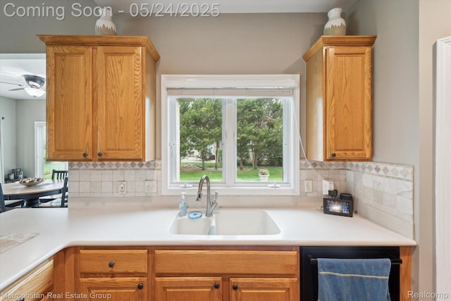 921 Gleneagles, Highland, MI 48357 - kitchen featuring a sink, dishwashing machine, light countertops, tasteful backsplash, and a ceiling fan