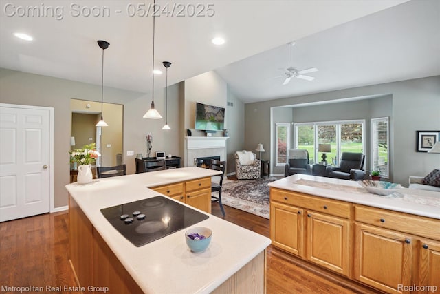 921 Gleneagles, Highland, MI 48357 - kitchen with black electric stovetop, open floor plan, a center island, ceiling fan, and lofted ceiling