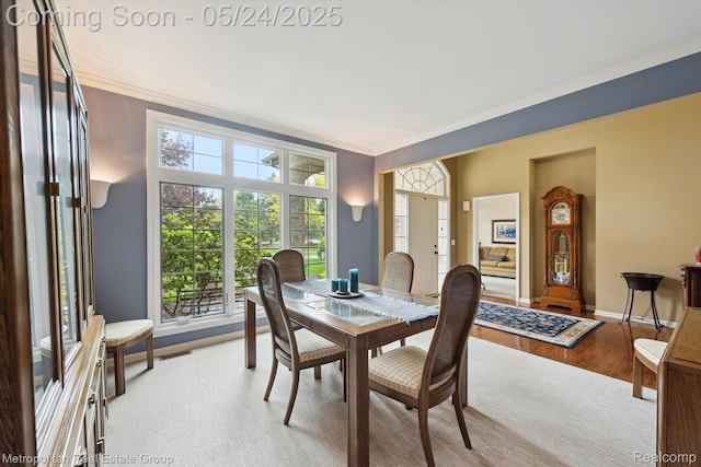 921 Gleneagles, Highland, MI 48357 - dining area with ornamental molding, plenty of natural light, light wood-type flooring, and baseboards