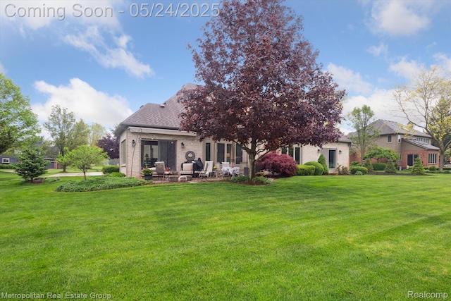 921 Gleneagles, Highland, MI 48357 - back of property featuring a lawn and a patio area