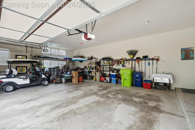 921 Gleneagles, Highland, MI 48357 - garage featuring a garage door opener