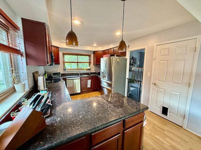 992 Key W Dr, Clawson, MI 48017 - kitchen with stainless steel appliances, a sink, light wood-style floors, a peninsula, and recessed lighting