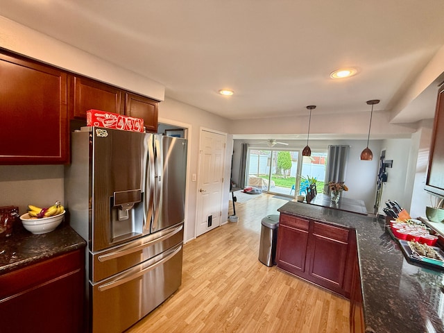 992 Key W Dr, Clawson, MI 48017 - kitchen featuring stainless steel fridge with ice dispenser, light wood-style floors, hanging light fixtures, dark stone countertops, and recessed lighting