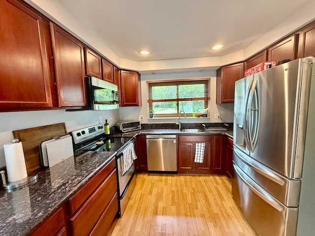 992 Key W Dr, Clawson, MI 48017 - kitchen featuring stainless steel appliances, a sink, light wood-style flooring, dark stone countertops, and recessed lighting