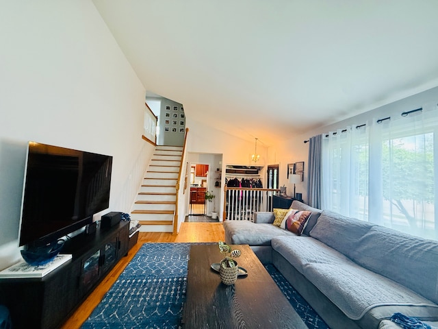 992 Key W Dr, Clawson, MI 48017 - living area featuring stairway, a chandelier, light wood-type flooring, and lofted ceiling