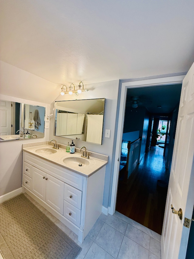 992 Key W Dr, Clawson, MI 48017 - bathroom featuring double vanity, tile patterned floors, and baseboards