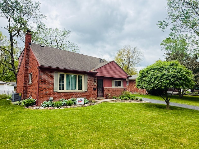 992 Key W Dr, Clawson, MI 48017 - ranch-style house with brick siding, a front yard, a chimney, a shingled roof, and cooling unit