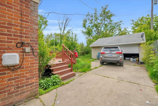 18305 Glastonbury Rd, Detroit, MI 48219 - view of side of property featuring a detached garage, a deck, and brick siding