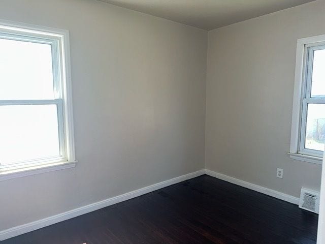1688 S Ethel St, Detroit, MI 48217 - empty room featuring dark wood-style floors and baseboards
