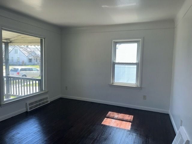 1688 S Ethel St, Detroit, MI 48217 - unfurnished room featuring healthy amount of natural light, dark wood finished floors, and baseboards