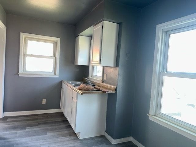 1688 S Ethel St, Detroit, MI 48217 - kitchen with white cabinets, a sink, and healthy amount of natural light