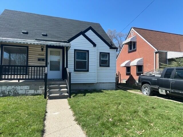 1688 S Ethel St, Detroit, MI 48217 - view of front facade with a porch and a front yard