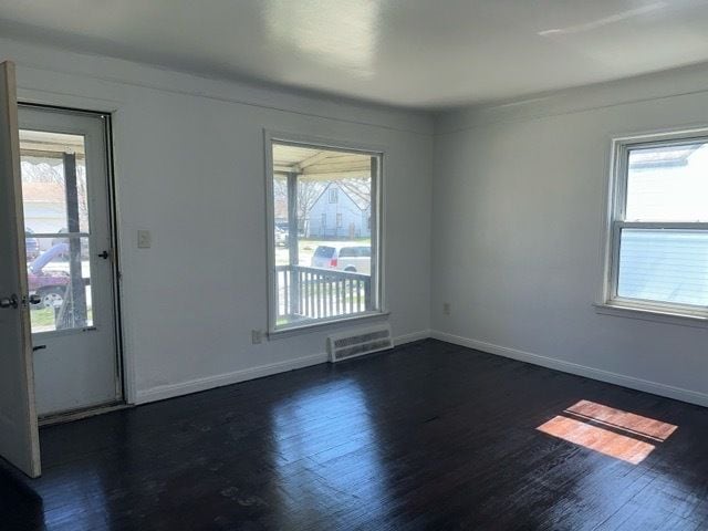 1688 S Ethel St, Detroit, MI 48217 - empty room with healthy amount of natural light and wood finished floors