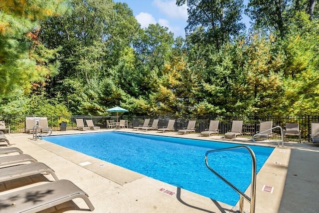 9366 E Locke Rd, Union Pier, MI 49129 - community pool with fence, a patio area, and view of scattered trees