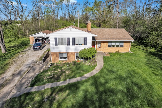 1930 Hogback Rd, Ann Arbor, MI 48105 - split level home featuring brick siding, a chimney, and a front lawn