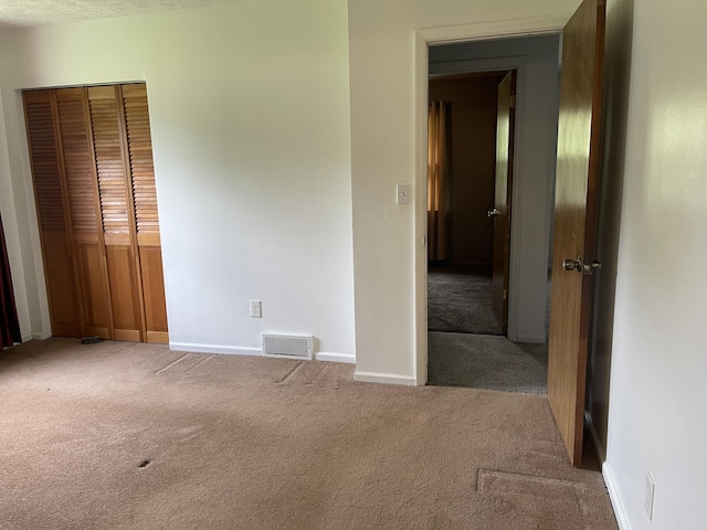 852 Maynard Ave, Jackson, MI 49202 - unfurnished bedroom featuring carpet flooring, baseboards, and a closet