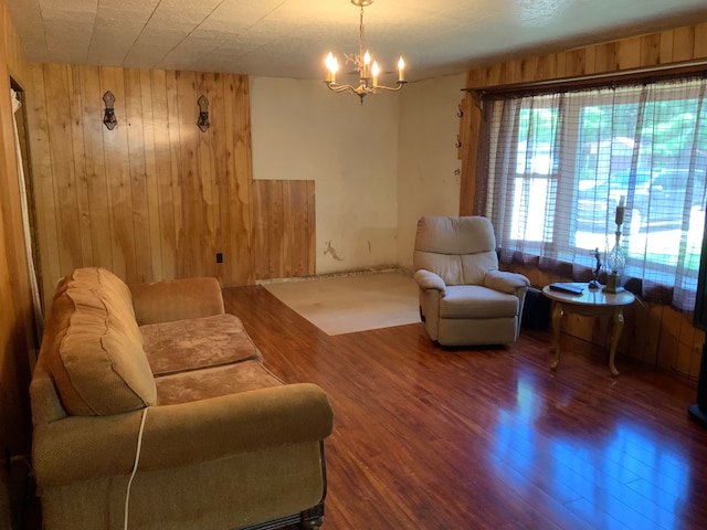 1483 W Bear Lake Rd NE, Kalkaska, MI 49646 - living room with wooden walls, a chandelier, and wood finished floors