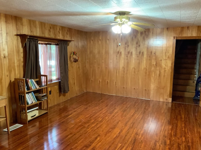1483 W Bear Lake Rd NE, Kalkaska, MI 49646 - unfurnished room featuring a ceiling fan, wood finished floors, and wood walls