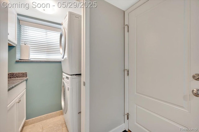 1227 Sycamore Dr, Rochester Hills, MI 48307 - washroom with estacked washer and dryer, baseboards, cabinet space, and light tile patterned flooring