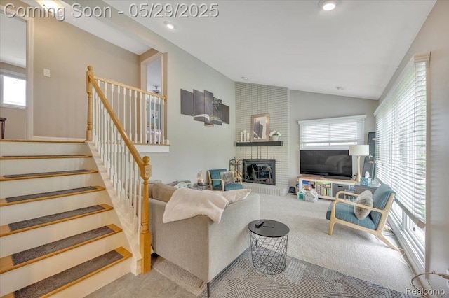 1227 Sycamore Dr, Rochester Hills, MI 48307 - carpeted living area featuring lofted ceiling, healthy amount of natural light, stairs, a fireplace, and recessed lighting