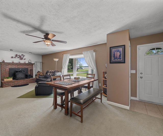 11589 Owosso Rd, Fowlerville, MI 48836 - dining room featuring light colored carpet, ceiling fan, a textured ceiling, baseboards, and light tile patterned floors
