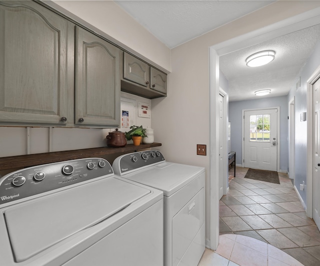 11589 Owosso Rd, Fowlerville, MI 48836 - clothes washing area with independent washer and dryer, a textured ceiling, light tile patterned flooring, and baseboards