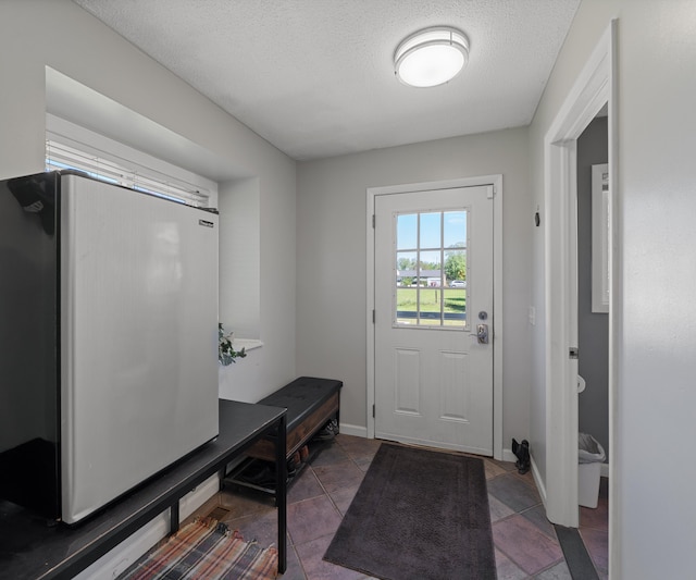 11589 Owosso Rd, Fowlerville, MI 48836 - mudroom with a textured ceiling and baseboards