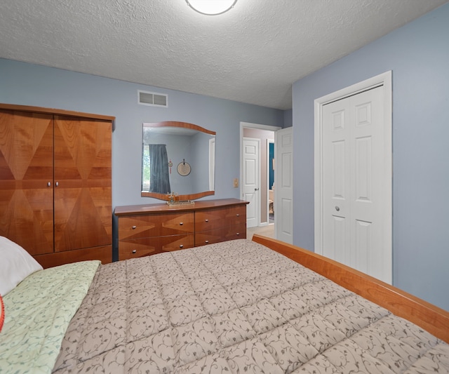 11589 Owosso Rd, Fowlerville, MI 48836 - bedroom with a textured ceiling, a closet, and baseboards