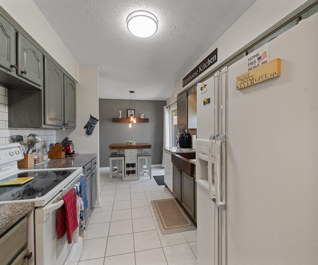 11589 Owosso Rd, Fowlerville, MI 48836 - kitchen with white appliances, light tile patterned floors, a textured ceiling, tasteful backsplash, and pendant lighting