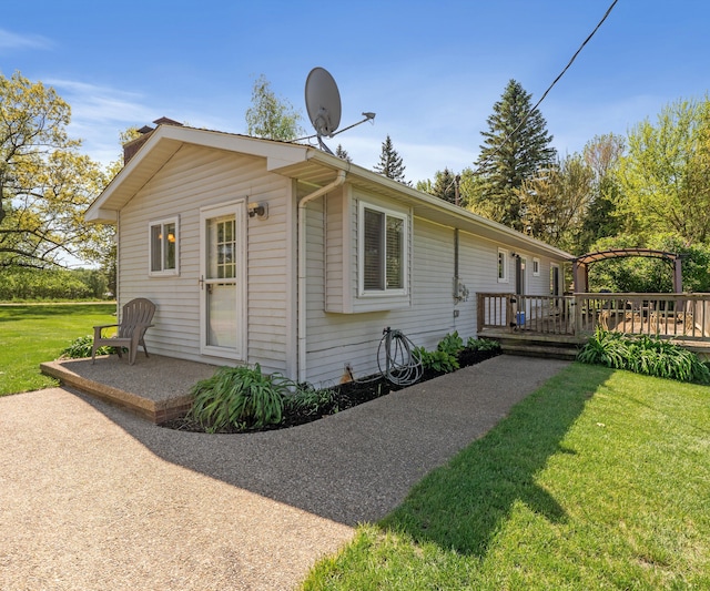 11589 Owosso Rd, Fowlerville, MI 48836 - view of property exterior featuring a deck and a lawn