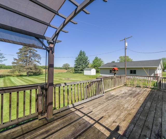 11589 Owosso Rd, Fowlerville, MI 48836 - deck featuring a storage shed, a pergola, an outbuilding, and a yard