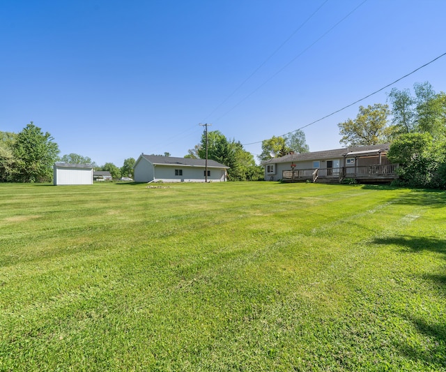 11589 Owosso Rd, Fowlerville, MI 48836 - view of green lawn featuring a wooden deck