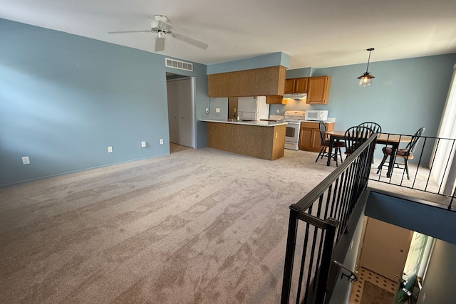 1478 Harbor Dr, Walled Lake, MI 48390 - kitchen with white appliances, brown cabinets, a ceiling fan, light countertops, and light colored carpet