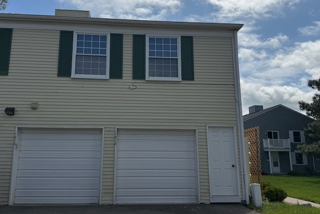 1478 Harbor Dr, Walled Lake, MI 48390 - garage featuring asphalt driveway