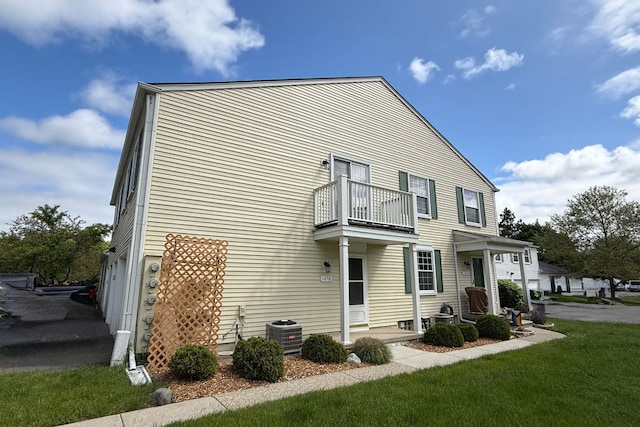 1478 Harbor Dr, Walled Lake, MI 48390 - view of home's exterior with a balcony, central air condition unit, and a lawn