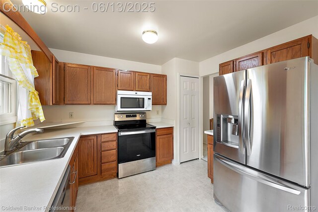 634 Eastway Cir Unit # 20, Lapeer, MI 48446 - kitchen featuring stainless steel appliances, brown cabinetry, and light countertops