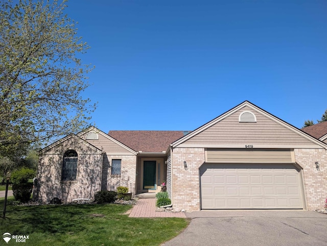 9419 Grandview Ct, Davison, MI 48423 - single story home with asphalt driveway, brick siding, an attached garage, and a front lawn