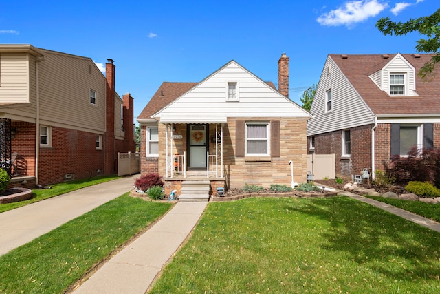 2270 23rd St, Wyandotte, MI 48192 - bungalow-style home featuring a front yard, covered porch, and stone siding