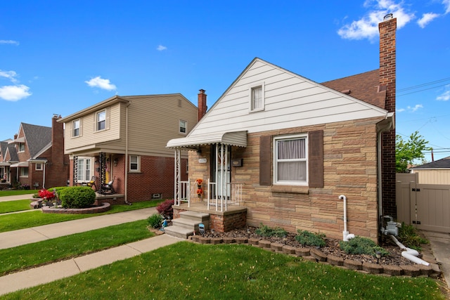 2270 23rd St, Wyandotte, MI 48192 - view of front of property featuring stone siding and a chimney