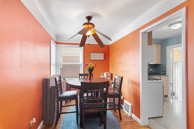 2270 23rd St, Wyandotte, MI 48192 - dining room with a ceiling fan, baseboards, and light wood-style flooring