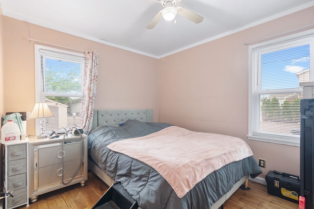 2270 23rd St, Wyandotte, MI 48192 - bedroom featuring light wood finished floors, multiple windows, crown molding, a ceiling fan, and baseboards