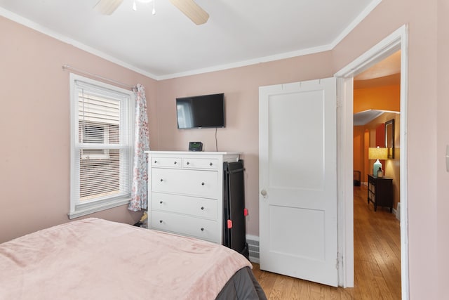 2270 23rd St, Wyandotte, MI 48192 - bedroom with light wood-style flooring, ornamental molding, a ceiling fan, and baseboards