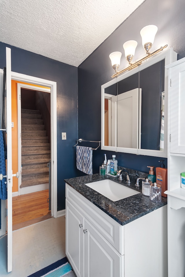 2270 23rd St, Wyandotte, MI 48192 - bathroom featuring vanity, tile patterned floors, a textured ceiling, and baseboards