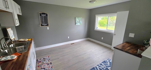 6241 Bermuda Ln, Mount Morris, MI 48458 - unfurnished dining area with a sink, baseboards, and light wood finished floors