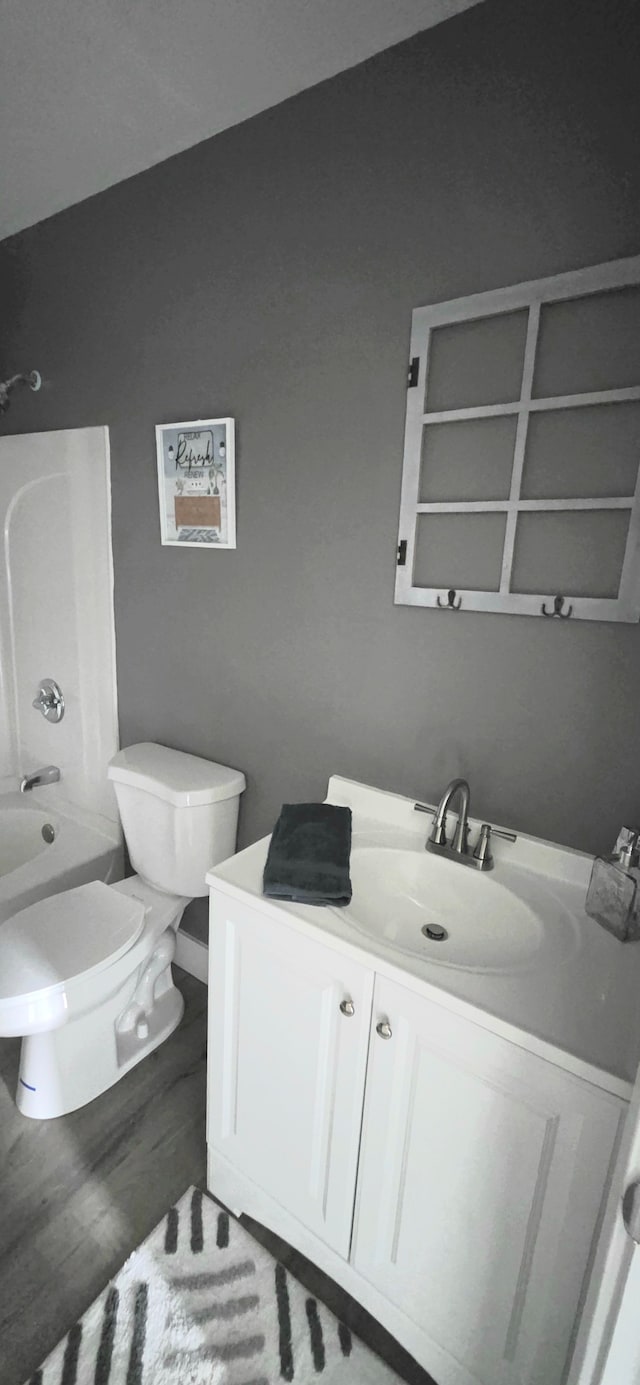 6241 Bermuda Ln, Mount Morris, MI 48458 - bathroom with toilet, vanity, bathtub / shower combination, and wood finished floors