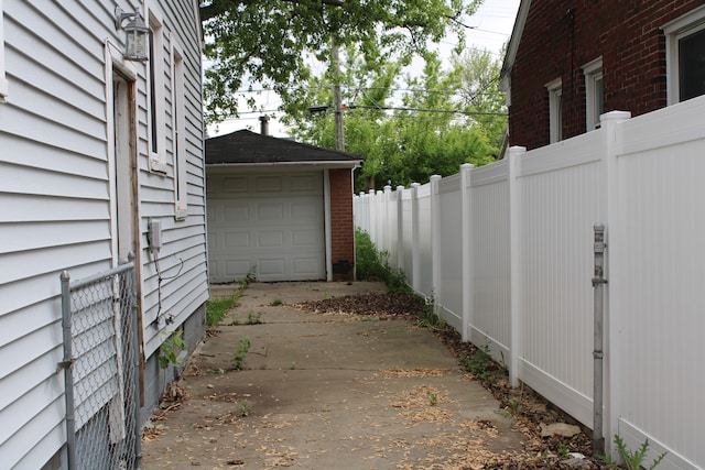 1093 Ford Blvd, Lincoln Park, MI 48146 - view of patio / terrace with driveway, a garage, and an outdoor structure
