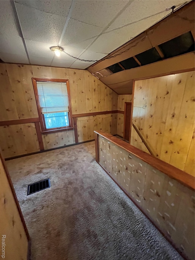 20711 Gaukler St, Saint Clair Shores, MI 48080 - additional living space featuring wooden walls, carpet, and vaulted ceiling