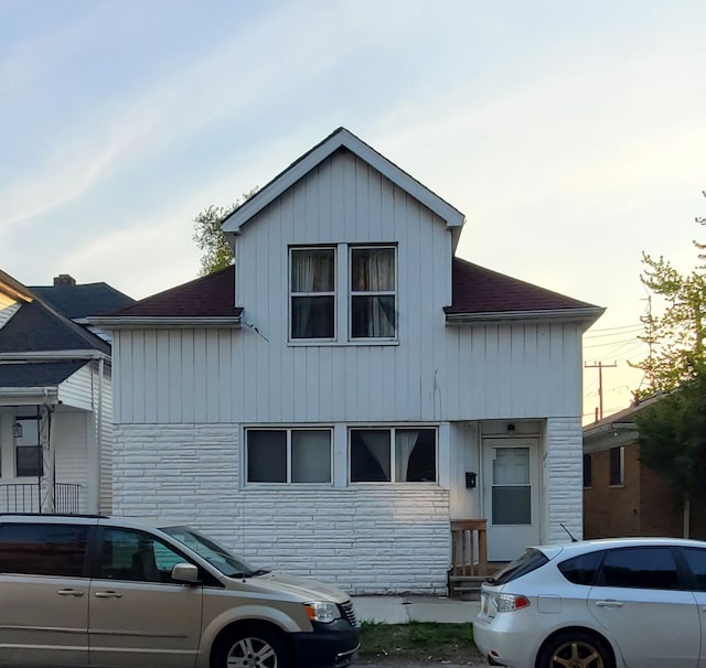 12153 Mcdougall St, Hamtramck, MI 48212 - view of front of home featuring a shingled roof and board and batten siding