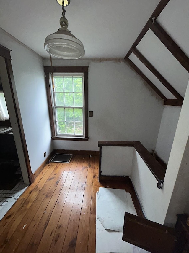 715 Avon St, Flint, MI 48503 - stairway featuring wood-type flooring, lofted ceiling, and baseboards